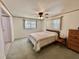 Inviting bedroom with a ceiling fan, bright windows, and a comfortable bed at 104 Chestnut St, Leesburg, FL 34748