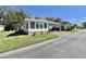 Attractive single-story home featuring lush green lawn and tidy landscaping at 104 Chestnut St, Leesburg, FL 34748