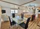 Open-concept living area with a dining table, kitchen island, and comfortable seating at 104 Chestnut St, Leesburg, FL 34748