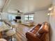 Spacious living room with hardwood floors, bright windows, and comfortable seating areas at 104 Chestnut St, Leesburg, FL 34748