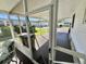 Outdoor patio with screen, offering an open view of the neighborhood at 104 Chestnut St, Leesburg, FL 34748