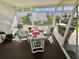 Cozy screened-in patio with comfortable seating, grill, and exterior views at 104 Chestnut St, Leesburg, FL 34748
