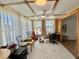 Bright sun room with tile flooring, large windows, and a ceiling fan at 104 Chestnut St, Leesburg, FL 34748