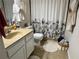 Cozy bathroom with decorative shower curtain, vanity, and a tile floor at 12237 Tavares Ridge Cir # 67, Tavares, FL 32778