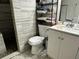 Bathroom featuring tiled walls, modern toilet, and vanity with a bright white sink at 12237 Tavares Ridge Cir # 67, Tavares, FL 32778