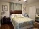 Cozy bedroom with decorative pillows, hardwood floors, and sun-blocking window shades at 12237 Tavares Ridge Cir # 67, Tavares, FL 32778