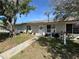 Charming single-story home featuring a well-maintained lawn, welcoming front door, and ample natural light through large windows at 12237 Tavares Ridge Cir # 67, Tavares, FL 32778