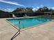 Community pool with crystal clear water and lounge seating on the pool deck at 12237 Tavares Ridge Cir # 67, Tavares, FL 32778