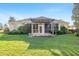 Backyard featuring a covered patio, lush green lawn and great landscaping at 12239 Se 92Nd Court Rd, Summerfield, FL 34491