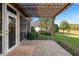 Backyard patio featuring a covered structure and well-maintained landscaping at 12239 Se 92Nd Court Rd, Summerfield, FL 34491