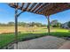 The backyard features a paver patio with pergola and a lawn at 12239 Se 92Nd Court Rd, Summerfield, FL 34491