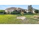 Wide angle view of the backyard featuring a large lawn and pergola covered patio at 12239 Se 92Nd Court Rd, Summerfield, FL 34491