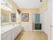 Bright bathroom features a soaking tub, separate shower, double vanity, and tile flooring at 12239 Se 92Nd Court Rd, Summerfield, FL 34491