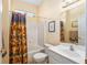 Bright bathroom features a shower over tub and stylish vanity at 12239 Se 92Nd Court Rd, Summerfield, FL 34491