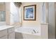 Beautiful bathroom with a soaking tub, separate shower, decorative window treatment, and stylish decor at 12239 Se 92Nd Court Rd, Summerfield, FL 34491