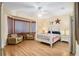 Charming bedroom with four-poster bed, sitting area, and plenty of natural light at 12239 Se 92Nd Court Rd, Summerfield, FL 34491