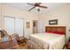 Comfortable bedroom with a ceiling fan, closet and decorative touches at 12239 Se 92Nd Court Rd, Summerfield, FL 34491
