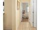 Hallway leading to a bedroom, showcasing tile floors, and a glimpse of a tranquil bedroom at 12239 Se 92Nd Court Rd, Summerfield, FL 34491