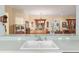 View from the kitchen pass-through into the dining and living area, creating an open and connected space at 12239 Se 92Nd Court Rd, Summerfield, FL 34491