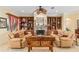 Spacious living room boasts built-in shelving, brick fireplace, and comfortable seating at 12239 Se 92Nd Court Rd, Summerfield, FL 34491