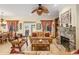 Inviting living room features a brick fireplace, wood accents, tile floors, and comfortable seating at 12239 Se 92Nd Court Rd, Summerfield, FL 34491