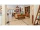 Bright living room features tile flooring, a built-in bookcase, and a comfortable seating arrangement at 12239 Se 92Nd Court Rd, Summerfield, FL 34491