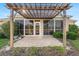 Covered patio featuring brick pavers, pergola and screened in porch at 12239 Se 92Nd Court Rd, Summerfield, FL 34491