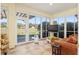Relaxing sunroom with tile flooring and bright views of the outdoors at 12239 Se 92Nd Court Rd, Summerfield, FL 34491
