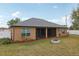 Back view of the home featuring a large, gray shingled roof at 13101 Biscayne Dr, Grand Island, FL 32735