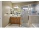 Bathroom featuring tiled floors, double sinks, and a shower and tub combination at 13101 Biscayne Dr, Grand Island, FL 32735