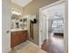 Bathroom entry from the main bedroom featuring double sinks and views to the bedroom at 13101 Biscayne Dr, Grand Island, FL 32735