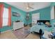 Bright bedroom with colorful decor, tile flooring, and ceiling fan at 13101 Biscayne Dr, Grand Island, FL 32735