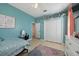 Bedroom featuring tile floors, a ceiling fan, and a double door closet at 13101 Biscayne Dr, Grand Island, FL 32735