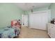 View of a bedroom featuring a closet, tiled floor and light-green painted walls at 13101 Biscayne Dr, Grand Island, FL 32735