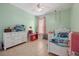Bright bedroom with a ceiling fan, light-green painted walls, and tiled floors at 13101 Biscayne Dr, Grand Island, FL 32735
