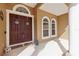 Inviting front entrance with double doors, arched windows, and a covered porch area. Welcome home! at 13101 Biscayne Dr, Grand Island, FL 32735