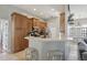 Eat-in kitchen with breakfast bar, stainless steel appliances, and ample cabinet space at 13101 Biscayne Dr, Grand Island, FL 32735