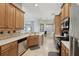 Well-lit kitchen with tile floors, wooden cabinets, and stainless steel appliances at 13101 Biscayne Dr, Grand Island, FL 32735