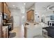 View of kitchen with wooden cabinets, stainless steel appliances, and breakfast bar seating at 13101 Biscayne Dr, Grand Island, FL 32735