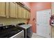 Laundry room featuring modern washer and dryer units and built-in cabinets at 13101 Biscayne Dr, Grand Island, FL 32735