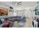 Cozy living area with tile flooring, a large gray sectional, and an open view into the dining room at 13101 Biscayne Dr, Grand Island, FL 32735