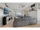 Spacious living room featuring tile flooring, a large sectional sofa, ceiling fan, and plenty of natural light at 13101 Biscayne Dr, Grand Island, FL 32735