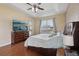 Main bedroom features hardwood floors, large dresser, ceiling fan, and natural light at 13101 Biscayne Dr, Grand Island, FL 32735