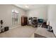 Home office featuring a large window, light-grey painted walls, and a ceiling fan at 13101 Biscayne Dr, Grand Island, FL 32735
