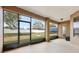 Screened-in back patio with a concrete floor and a view of the lawn and perimeter fence at 13101 Biscayne Dr, Grand Island, FL 32735