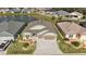 The home is set against a scenic pond, enhanced by lush landscaping and features a spacious three-car garage at 1581 Rowell St, The Villages, FL 34762
