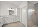 Bathroom featuring a vanity, a storage cabinet and frameless glass shower door at 1581 Rowell St, The Villages, FL 34762