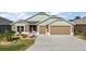 Charming single-Gathering home featuring a well-maintained lawn and a two-car garage at 1581 Rowell St, The Villages, FL 34762
