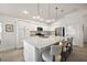 This spacious kitchen features stainless steel appliances, a large island with barstool seating and granite countertops at 1581 Rowell St, The Villages, FL 34762