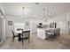 Bright kitchen features an island with bar seating, stainless steel appliances and an adjacent eat-in area at 1581 Rowell St, The Villages, FL 34762